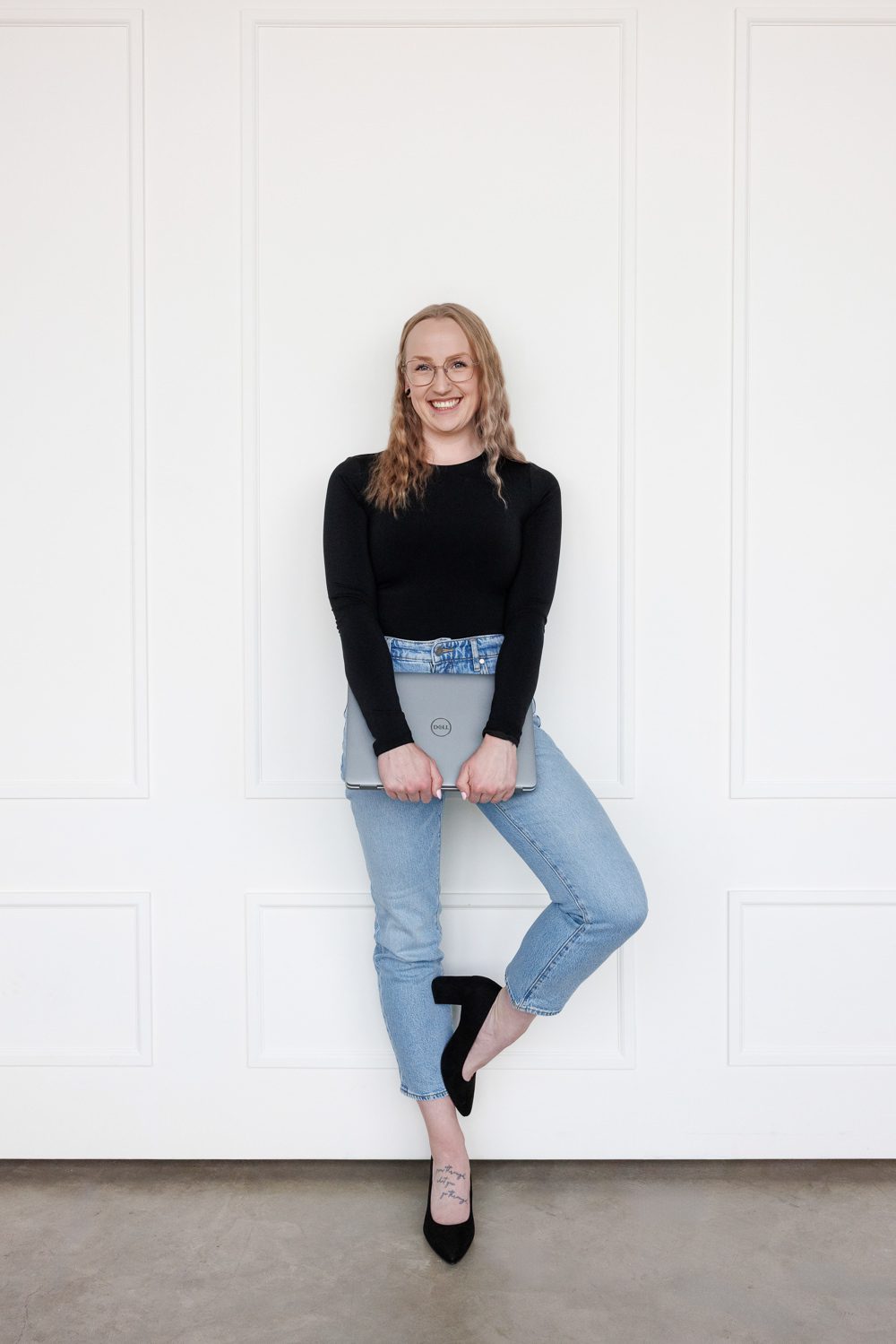 Clean, modern personal brand photos for websites taken at The Gallery Studio in Calgary, featuring a woman entrepreneur photographed by Kate Daniel Photography.