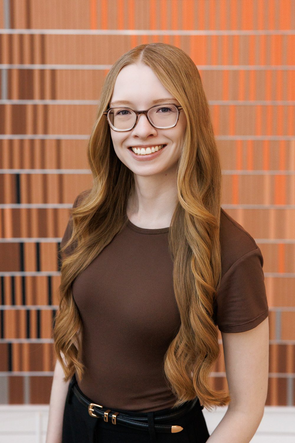Psychologist headshot in downtown Calgary with architectural interior and natural light
